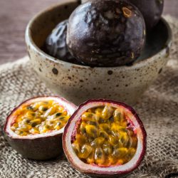 Fresh juicy passion fruit on wooden background